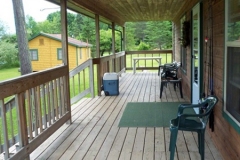 Relax anytime on our cabin's spacious porch